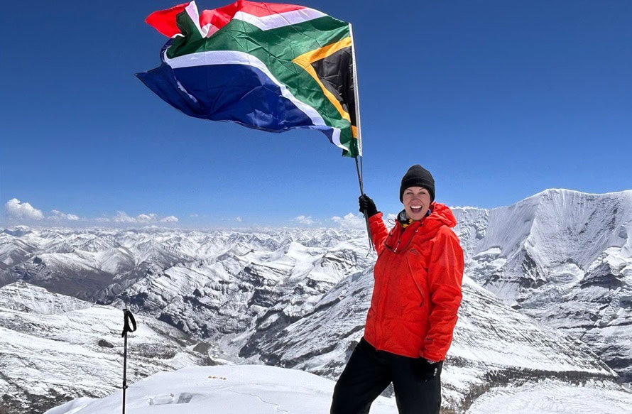 SA flag flutters above clouds